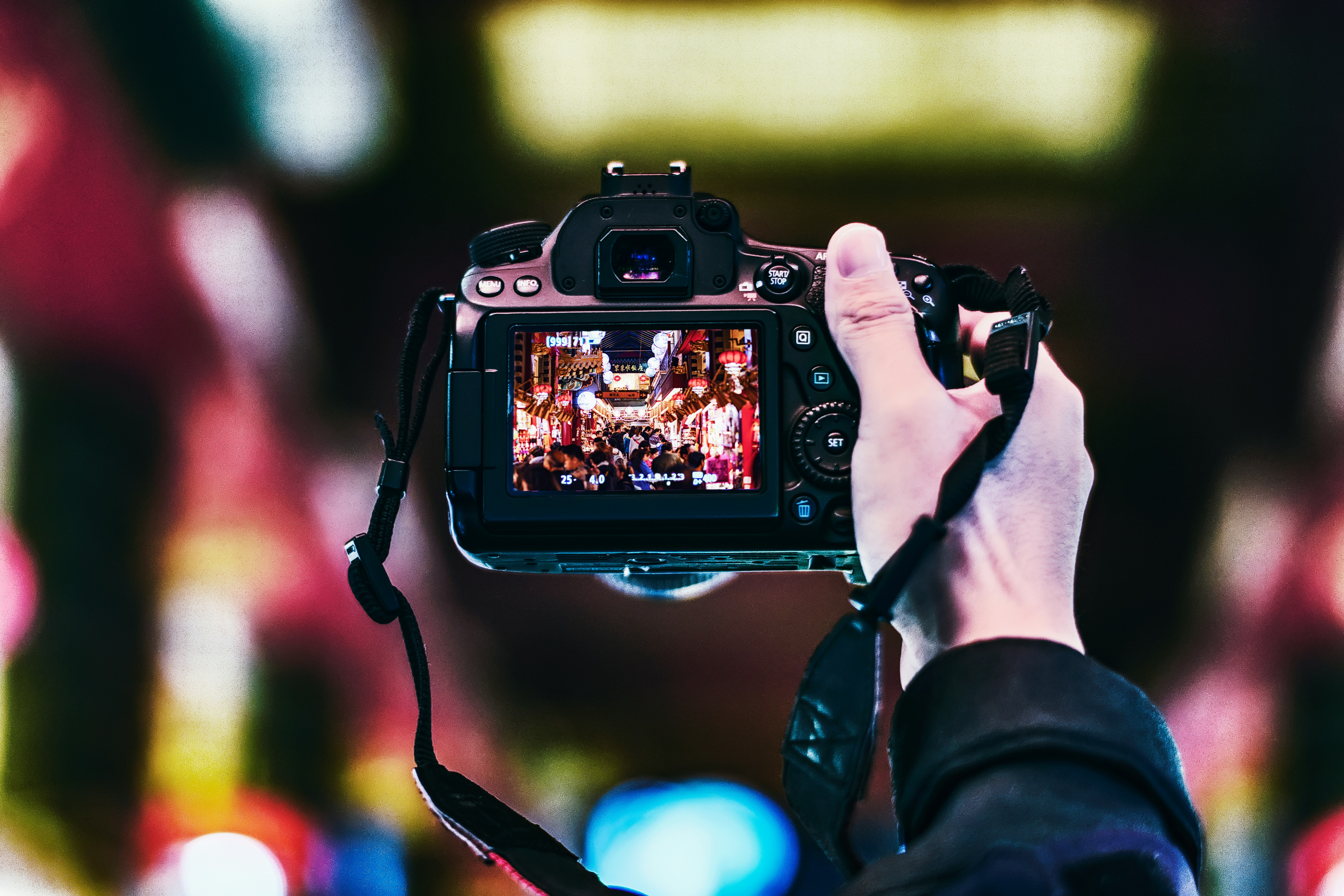 person holding black DSLR camera